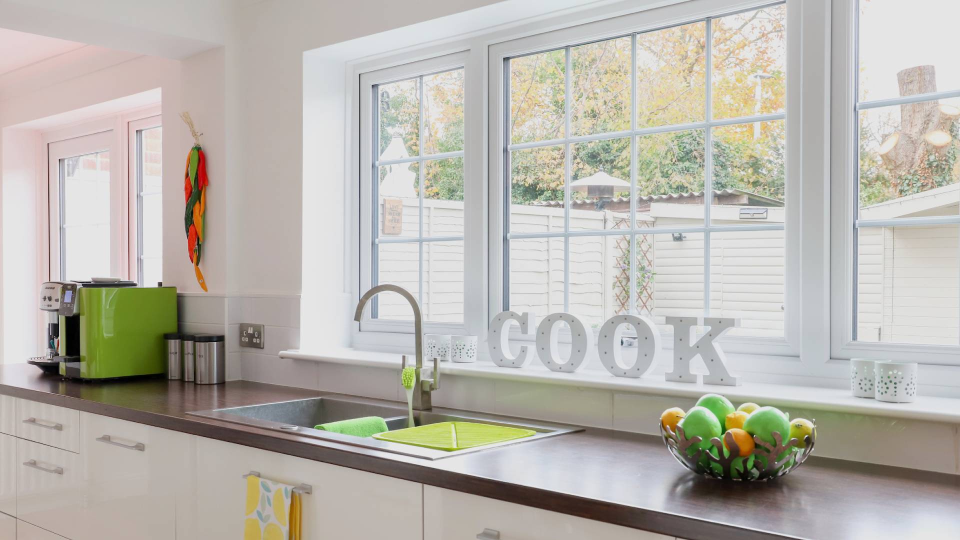 White kitchen with wood countertop and large window