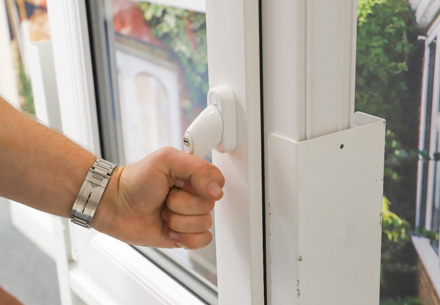 Person opening a white Everest conservatory window