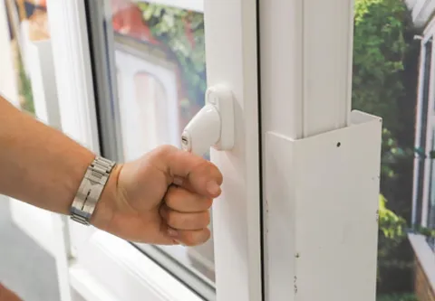 Person opening a white Everest conservatory window