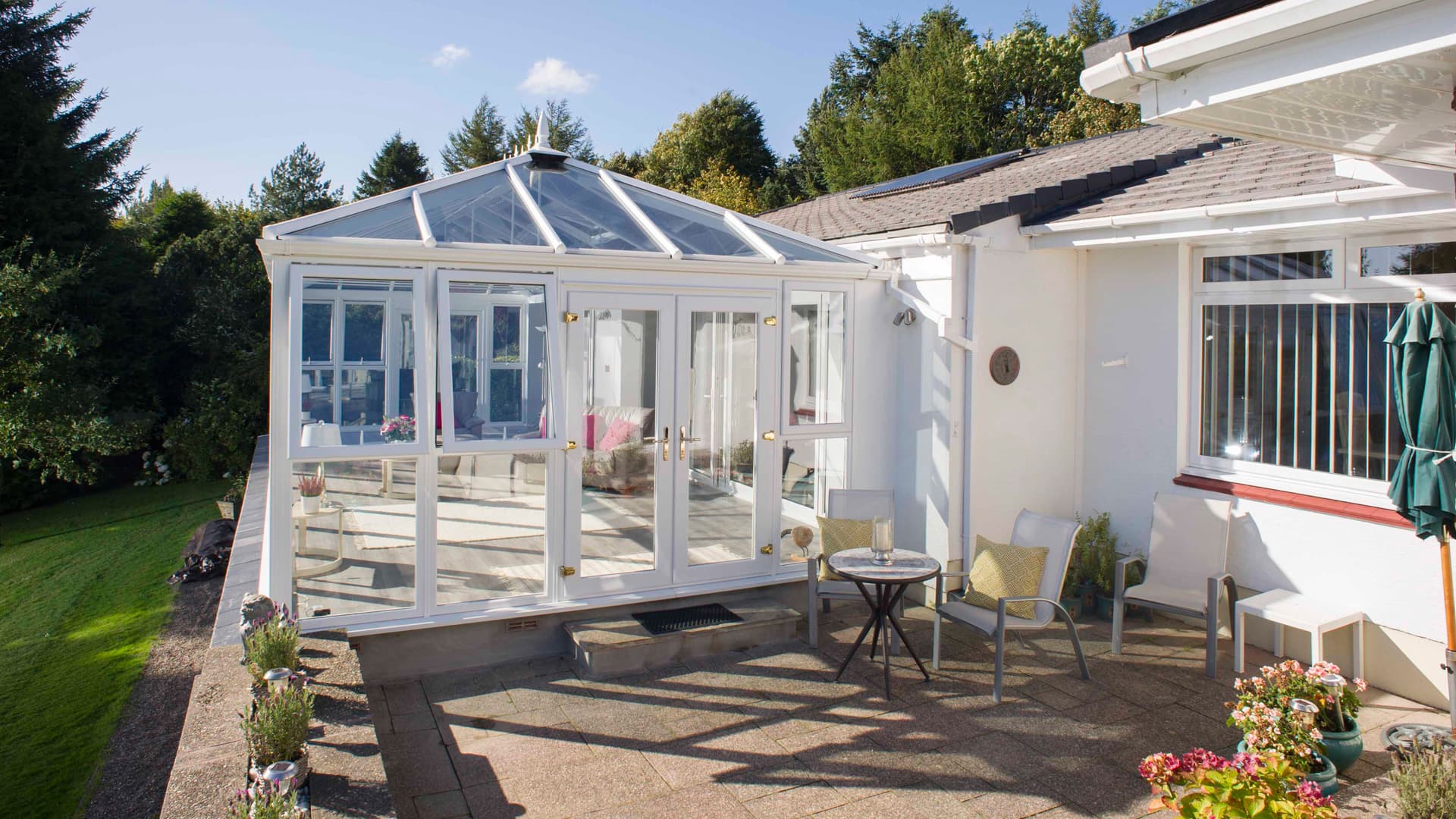 White Everest conservatory with patio furniture