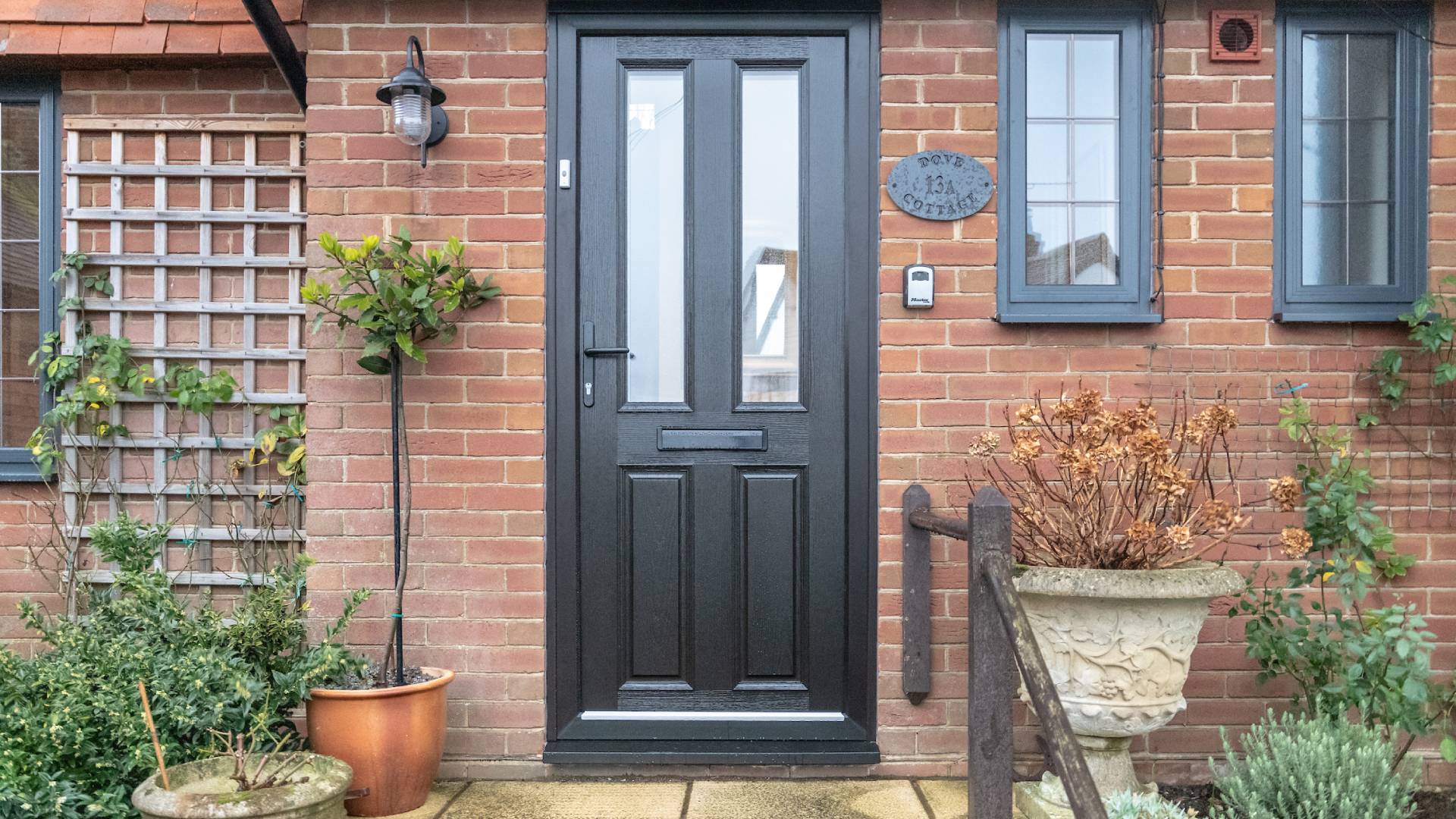 Black door with glass panels on brick house