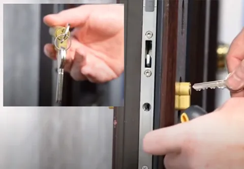 Hands inserting key into Everest conservatory door lock