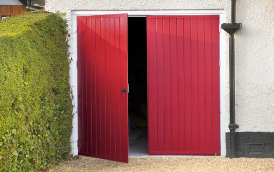 Red garage doors open to garage interior