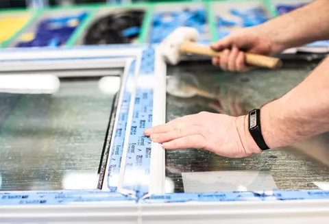 Installing blue sealant on Everest conservatory window frame