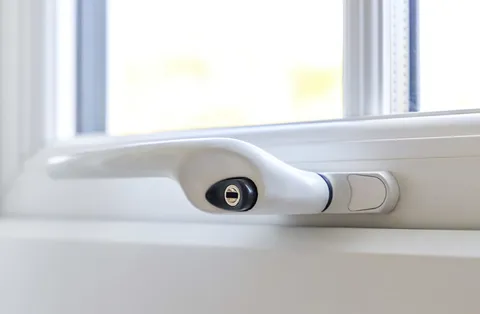 White window handle with lock and security features