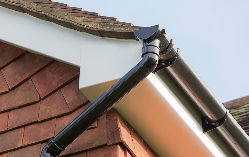 Black gutter on white fascia board of Everest conservatory
