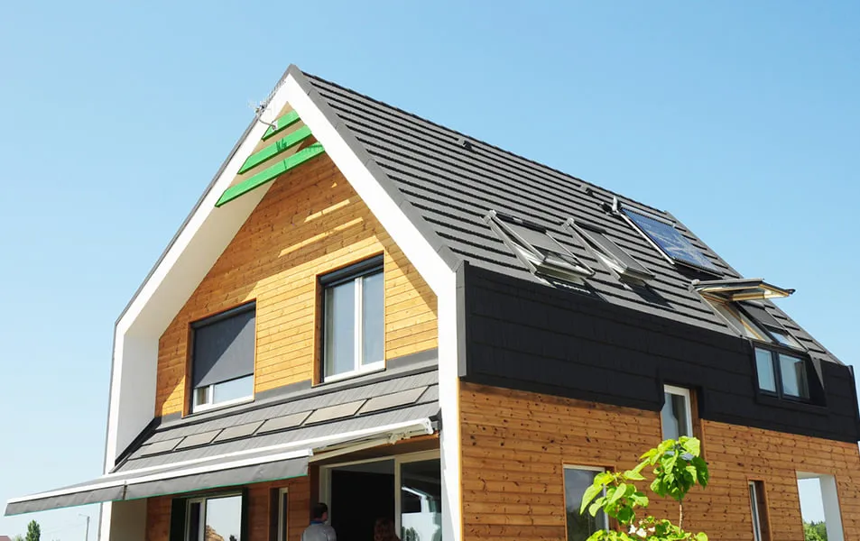 Everest home with dark grey roof and light brown siding