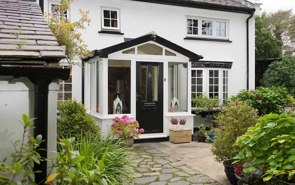 White house with black Everest conservatory and door