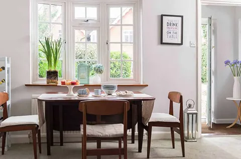 White Everest uPVC casement window with a chrome modern handle in a lounge