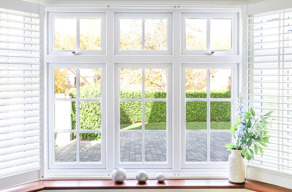 White Everest conservatory window with multiple panes and garden view