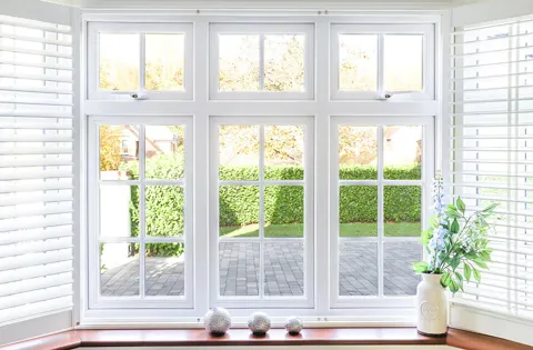 White Everest conservatory window with multiple panes and garden view