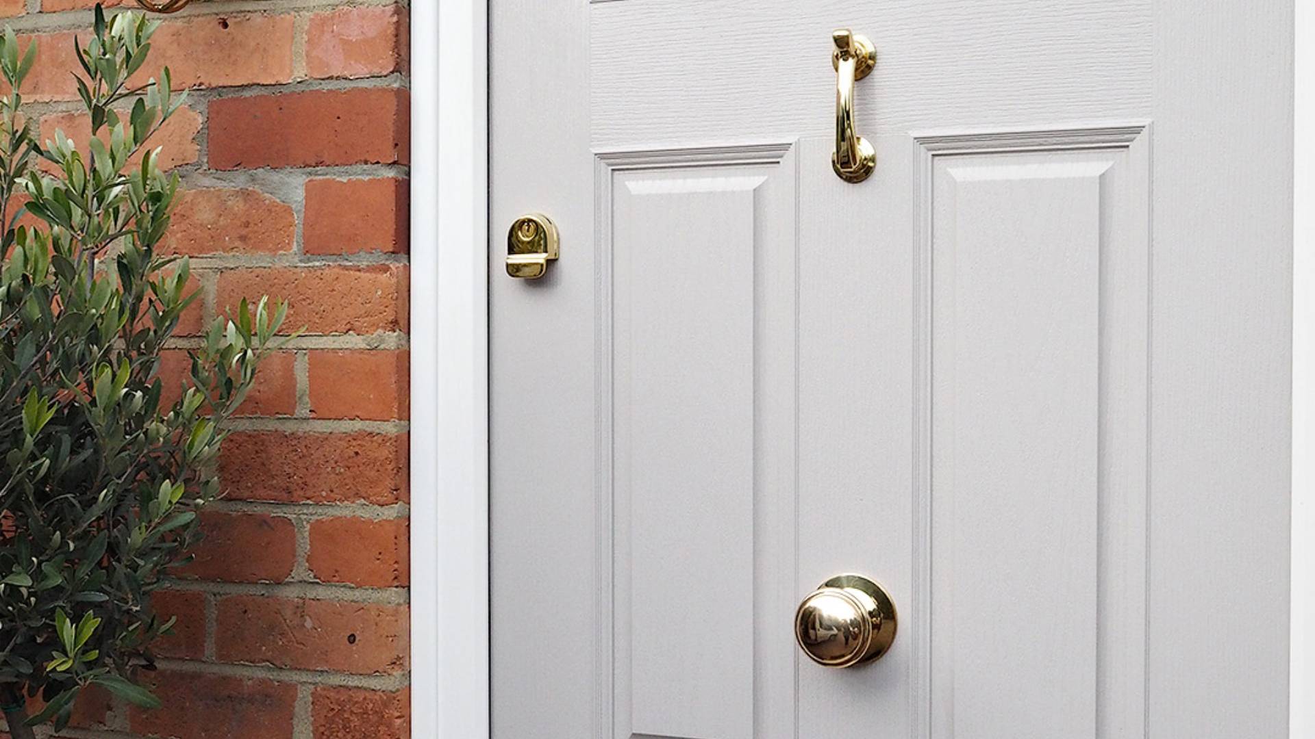 Light grey door with gold door hardware