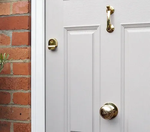 Light grey door with gold door hardware