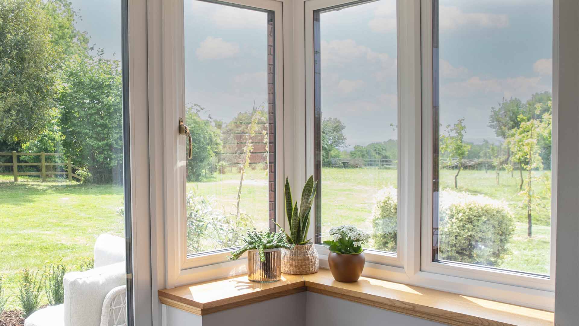 Everest conservatory corner window with plants and garden view